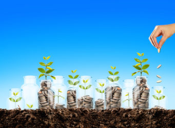 hand putting a coin in jar, saving money