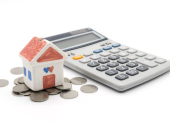 House and calculator on white background