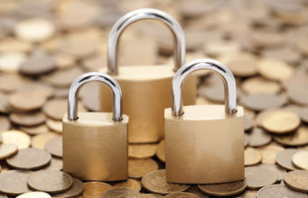 Financial security. Golden coins and padlocks.