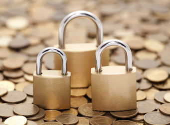 Financial security. Golden coins and padlocks.