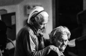 old woman sitting and comforting each other