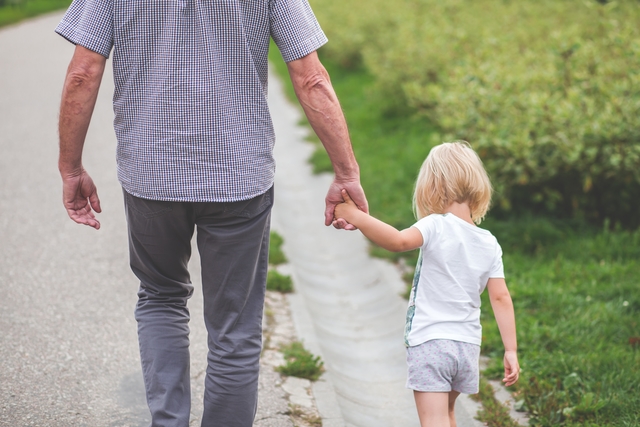 Photo of parent walking with their child