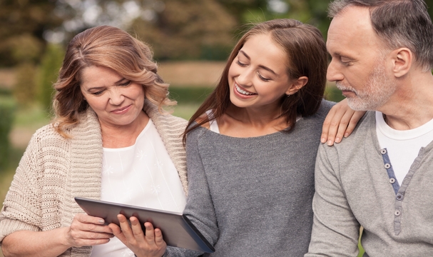 Photo of family viewing a tablet