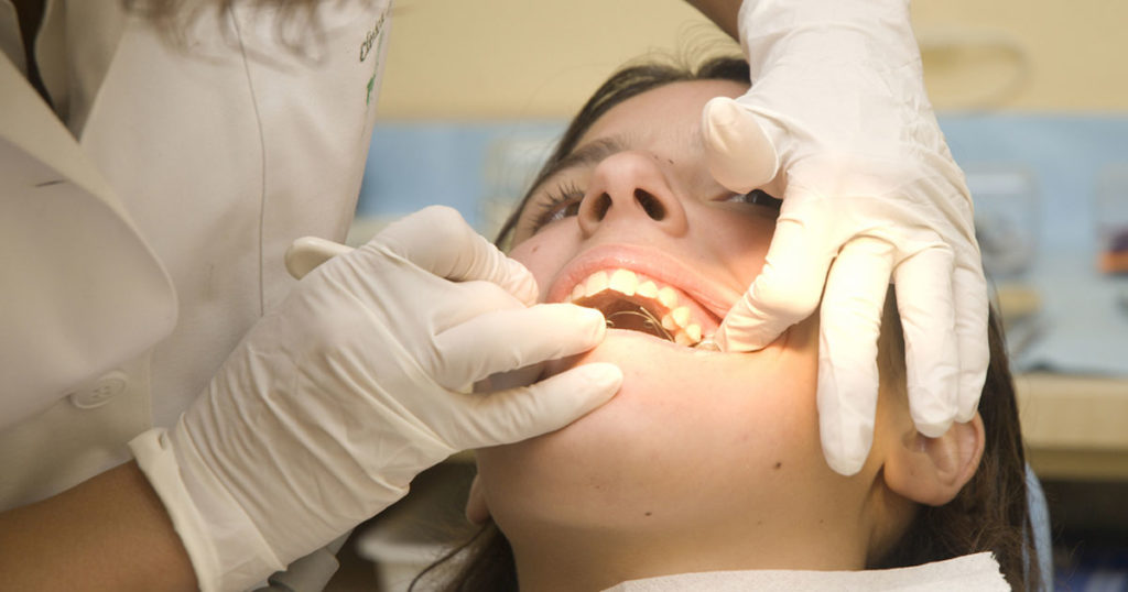 Woman having root canal at the dentist