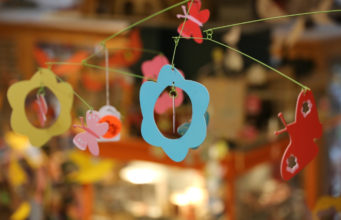 Crib mobile with shapes of butterflies and flowers