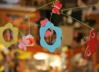 Crib mobile with shapes of butterflies and flowers